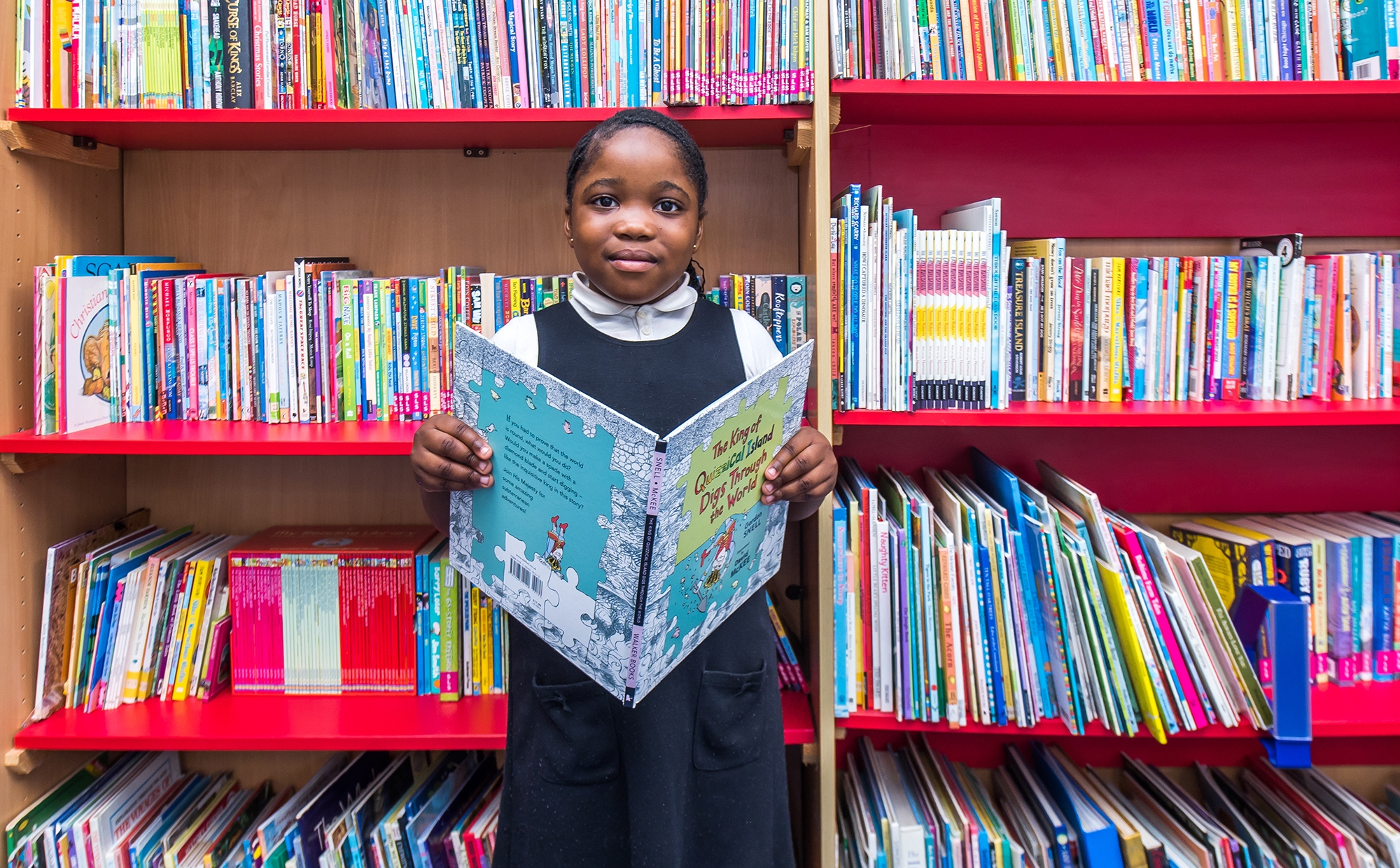 Pupil in the library at St Philip's CE Primary School