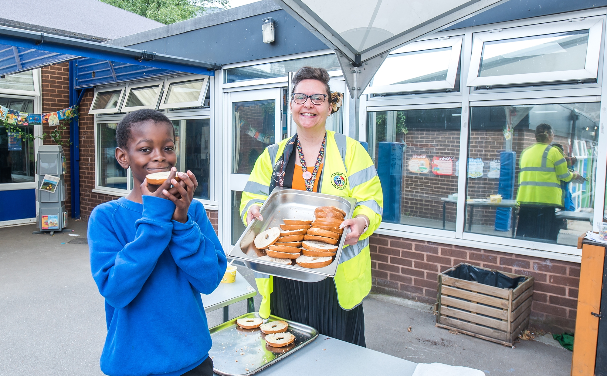 Pupil enjoying a morning bagel at St Philip's CE Primary School